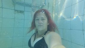 Going underwater in sexy black bikini and blowing bubbles