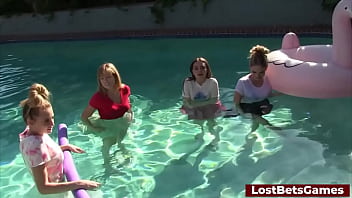 Four girls are enjoying stripping in the swimming pool, with one lucky guy joining them