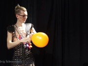 Nicky as a superhero destroys balloons