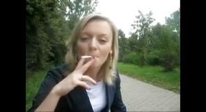 Blonde beauty smoking a cigarette outdoors