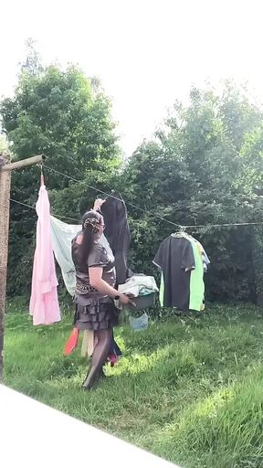 In an outfit with a charcoal colored ruffled dress to gather the laundry.