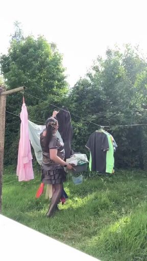In an outfit with a charcoal colored ruffled dress to gather the laundry.