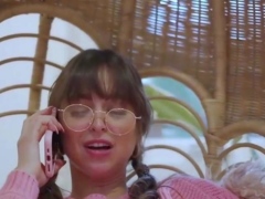 Petite brunette in pink sweater enjoys phone sex