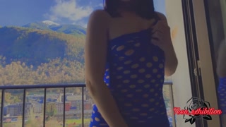 student showing off on the balcony of the city