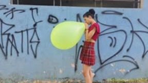 Emma Blows to Pop a 16" Neon Balloon