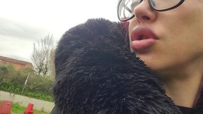 a red-haired woman with full lips sits on a park bench, letting out loud burps without a care in the world