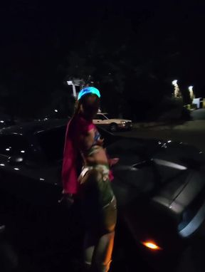 Woman in costume standing by car