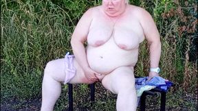 Stepmom in the park undressing and masturbating on a bench
