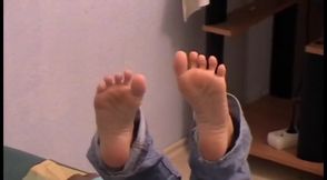 Reading newspaper and relaxing tired feet