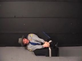 Cop pigtied and ball gagged.