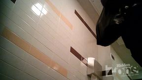 Blonde girl pissing in the toilet on the
