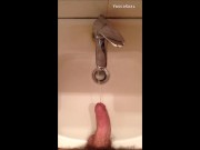 Peeing into wash basin in  restroom