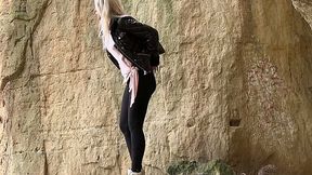 Straight blond haired cutie leans over the rock and pees right away