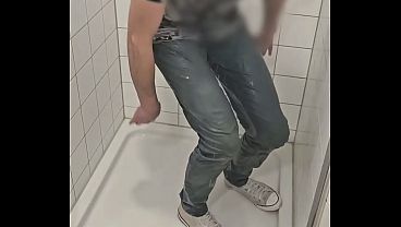 Playing in shower fully clothed with jeans and sneakers