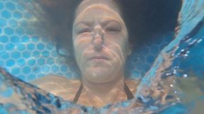 Underwater bubbles, and rings in black bikini and long hair