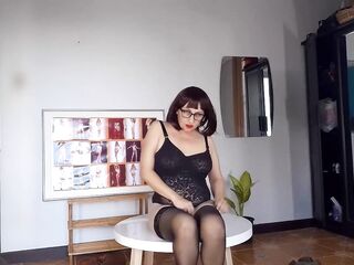 Regina Noir trying on high heels. Striptease in dark lingerie and stockings 1