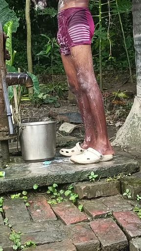 Black mature man bath in desi style. Showing big dick.   Clip 1