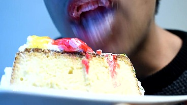 Eating cake with his mouth