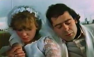 Young cute bride in the wedding dress with her man in the car