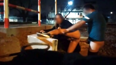 Blonde Argentinian woman exposes herself barefoot on city streets under streetlights
