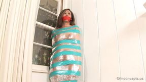 Leggy Anastasia Black Stands Barefoot Wrapped In Light Blue Tape Over Plastic Plus A Red Tape Gag!