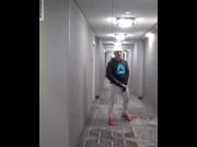 athlete in tights takes his cock out in hotel hall
