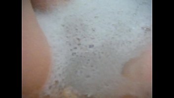 Sultry redhead milf Annie gets comfy in the bath, fingering her pussy