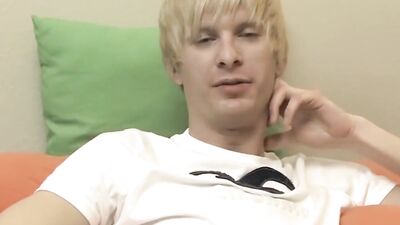 Blonde twink Liam Summers smiles to the camera while jerking off