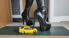 Requested clip Nikkichick crushes a yellow street race car in big stiletto boots and dangles it on her heel close ground view