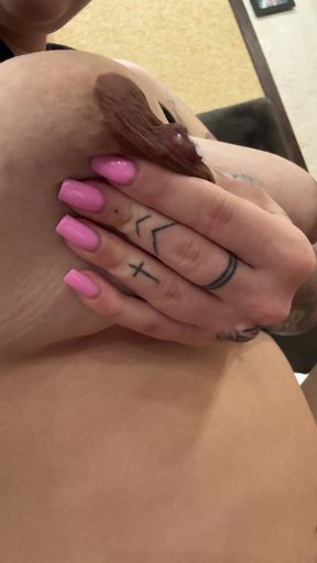 Lactating babe shows off her milk-filled tits