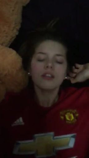 Woman in red jersey lying down
