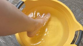 A young woman makes foot baths