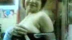 Dark haired giggling Arab nympho plays with her huge boobies