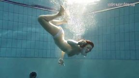 Brunette big tits teen Andrea swimming in the pool