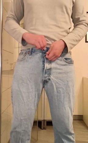 Uncut man jerks his cock while peeing