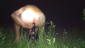 Anus Accepts a Black Dildo in the Middle of a Field in Nature. Yo, the Singing of Birds and Crickets.