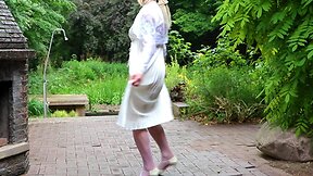 Pleated satin gown and nylon stockings: a caning experience