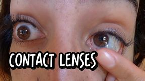 Close-up of contact lens insertion