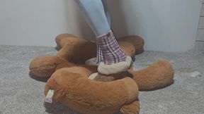 Mickee slippers and fuzzy socks jumping on big stuffy