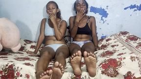 Best friends smoking together in bed and wiggling toes