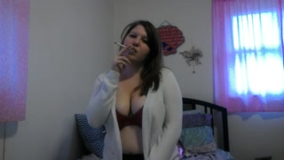 Busty girl smokes and gives a peak