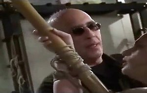 Tied to bamboo and getting a caning