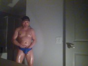 Oiled up and posing while wearing Speedos!