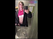 Femboy undresses in a public restroom.
