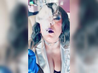 Dressed In Silver & Gloves & Rings Tina Snua Smoke A Supeking Cigarette