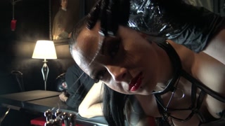 Mistress Nyx opens the slave's ass with a spreader and fists him to the sound of extreme metal