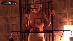 Lady Sonia caged and strips nude in the lovemaking dungeon