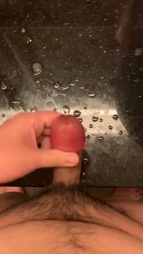 rubbing my big swollen cock head until i sprayed all over the table