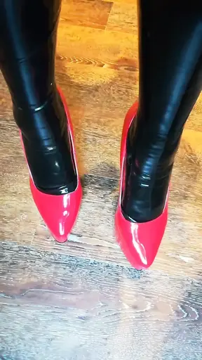 Alice Latexy models in stilettos and black and red latex (aka Latexdesires)