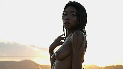 Ebony beauty from Cameroon Mimi Desuka gets naked in a pool for Playboy